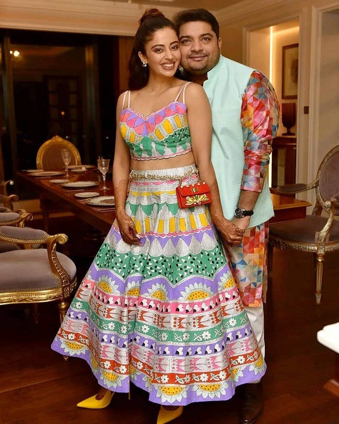 Neha-pendse-in-a-vibrant-lehenga-with-her-husband